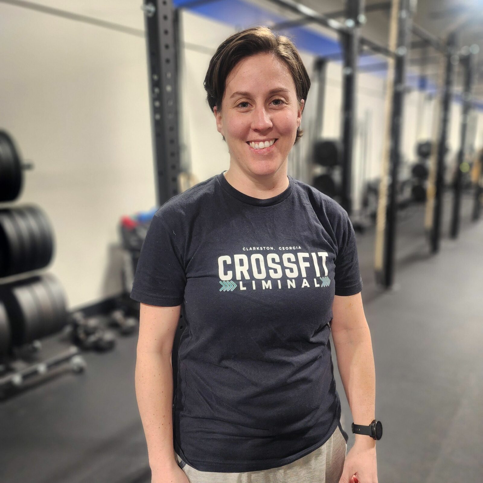 Member of board of directors posing for photograph, wearing CrossFit Liminal t-shirt.