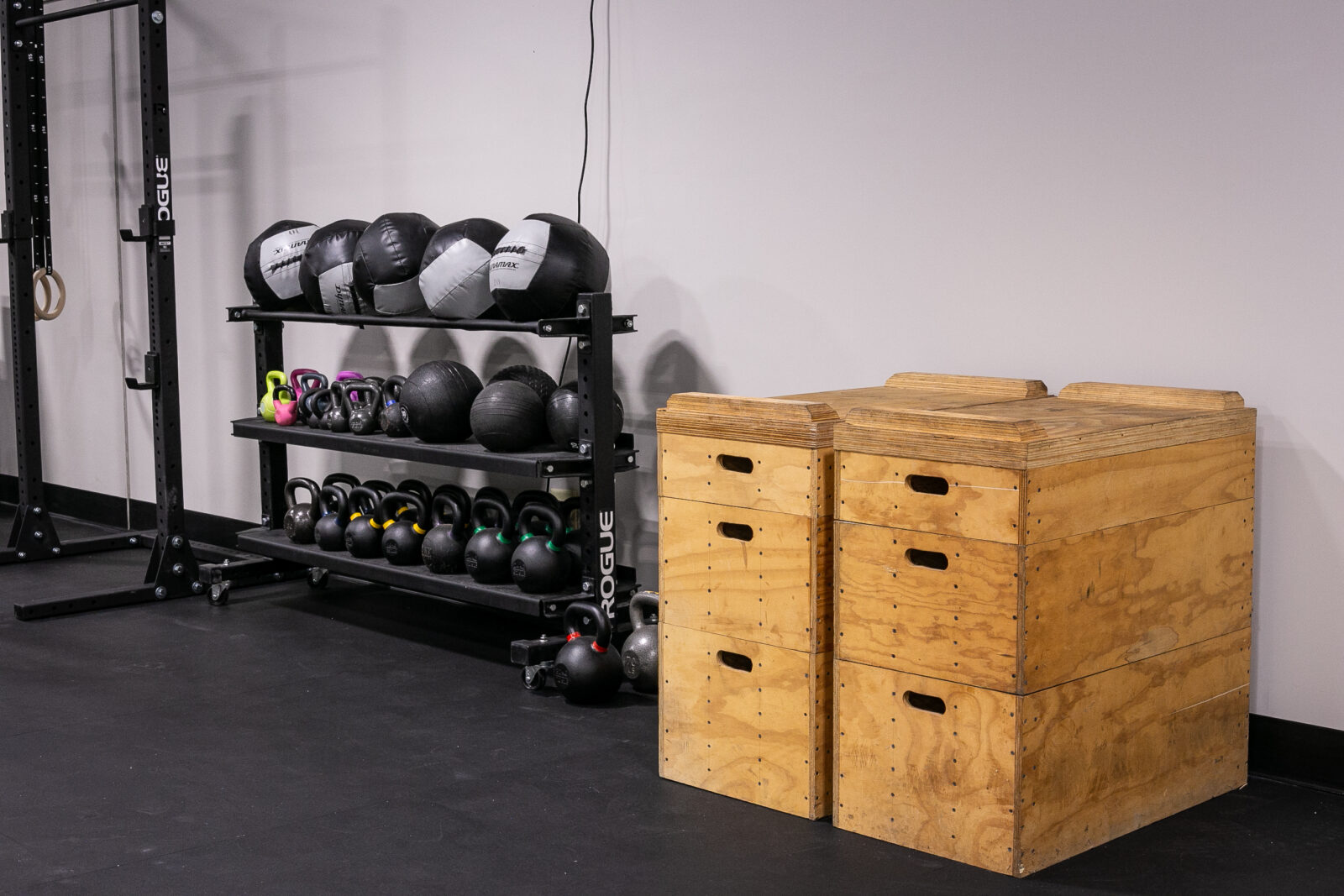 Shelf of gym equipment next to a stack of boxes.